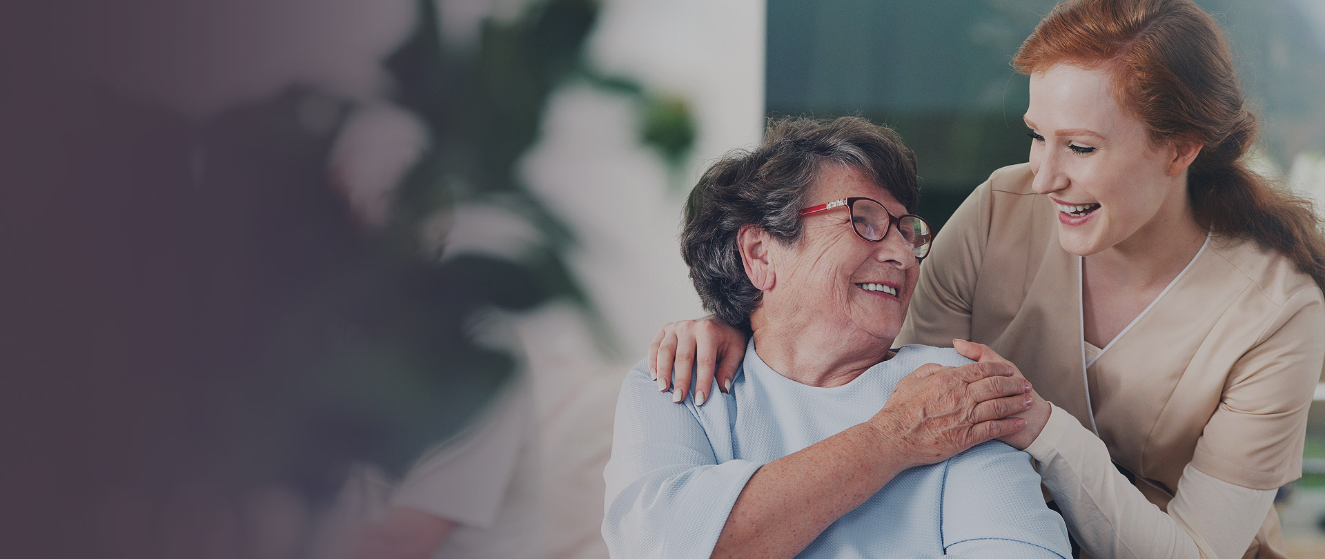 smiling caregiver with old lady